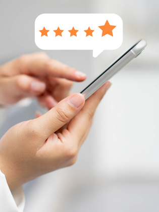 Person holding smart phone leaving a 5 Eli Moore Google review