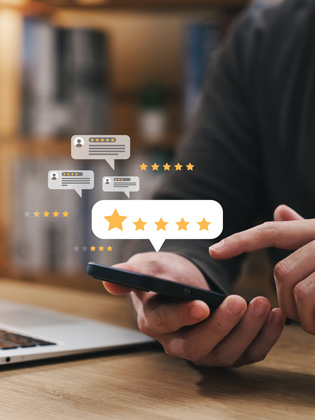 Person holding phone while leaving a 5 Eli Moore Google review